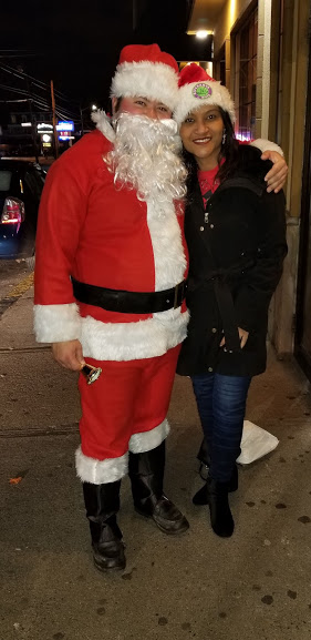 Santa Claus and a woman wearing a Santa hat