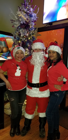 Santa Claus and two of our female staff