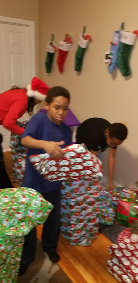 Children carrying wrapped gifts, blurred