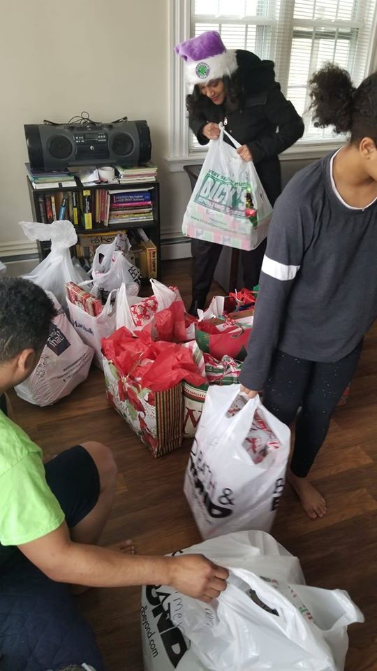 People carrying bags of gifts from the living room
