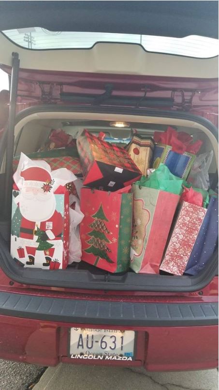 A red car with a trunk full of gifts, 2