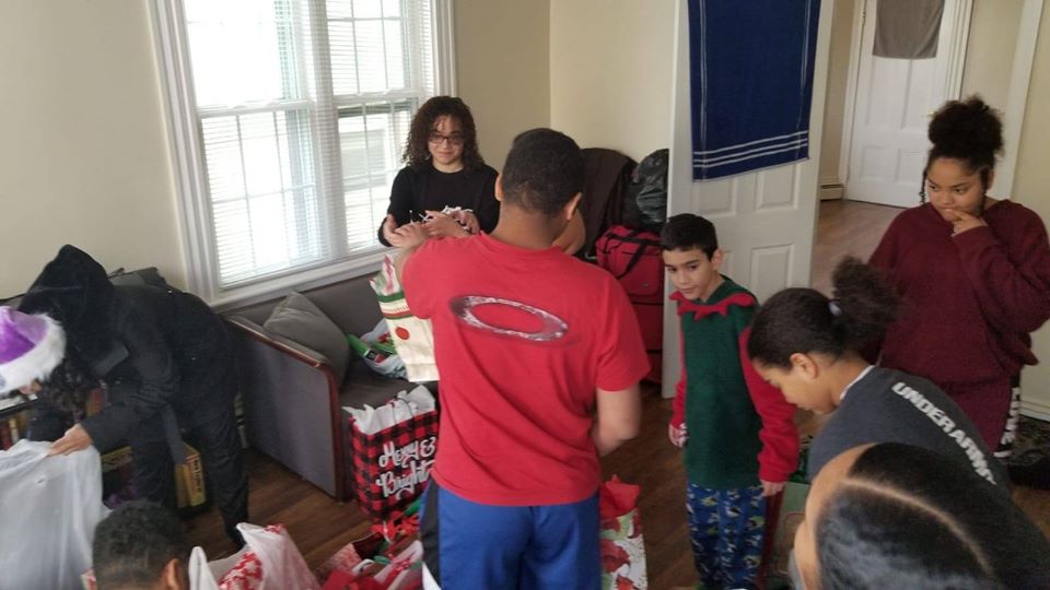 A group of children helping put the gifts in bags
