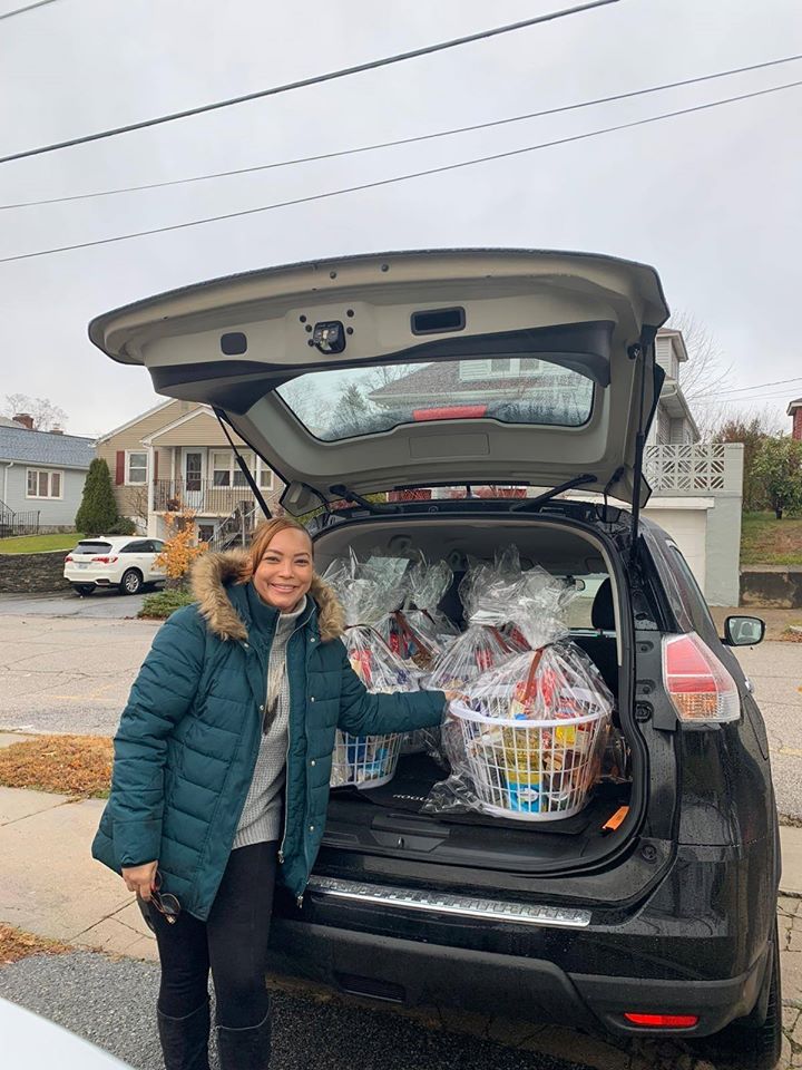 A woman and a car trunk full of food baskets