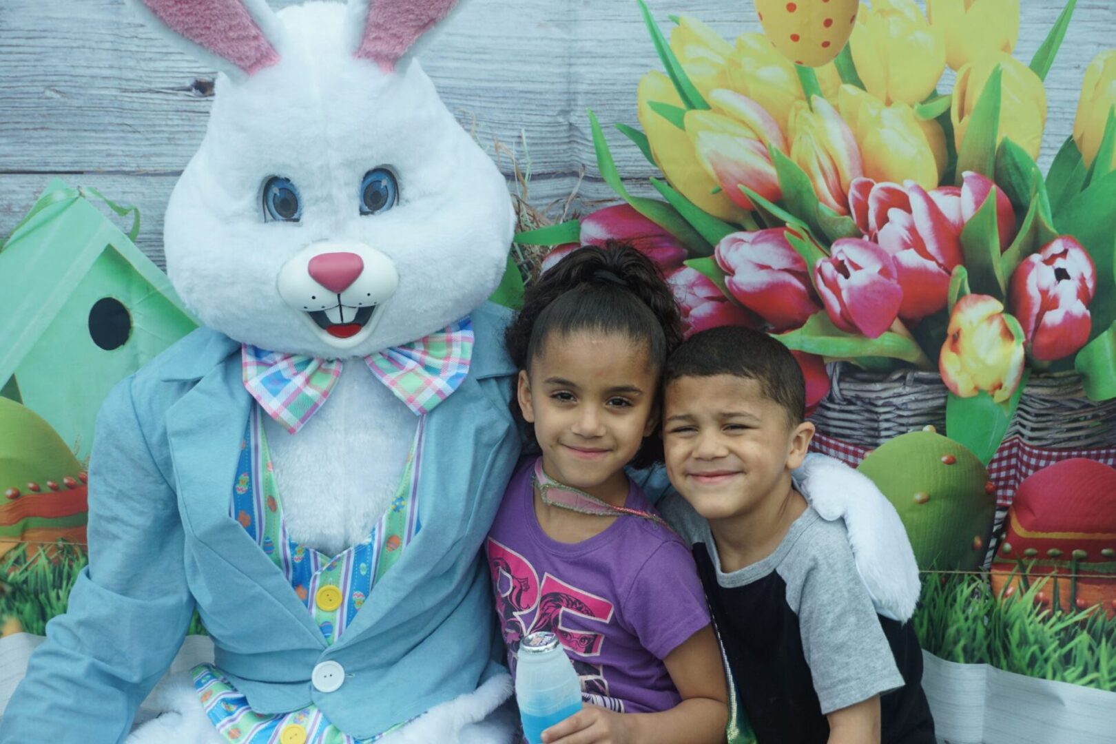 The bunny mascot together with a girl holding a drink and a boy (1)