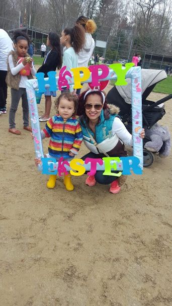 A woman and a young child posing with the Happy Easter frame