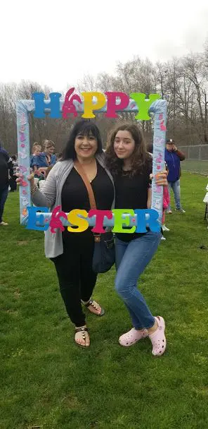 Two women posing black tops posing with the Happy Easter frame