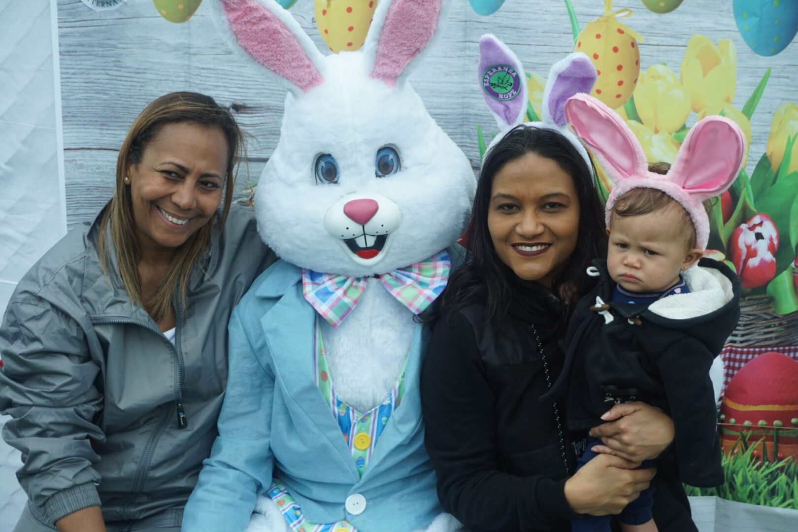 The bunny mascot together with two of our female staff with one of them holding a baby with bunny ears (2)