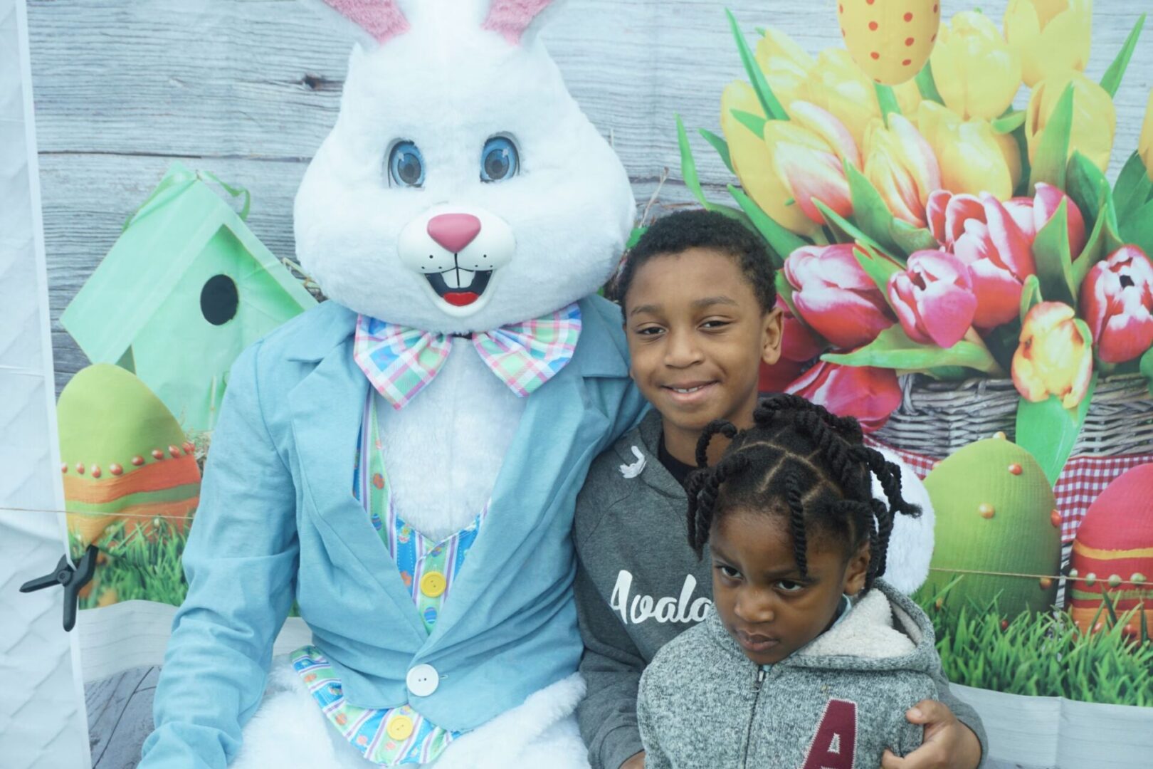 The bunny mascot and two kids wearing gray jackets