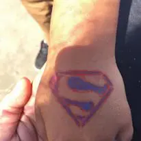 Superman’s logo on a child’s hand
