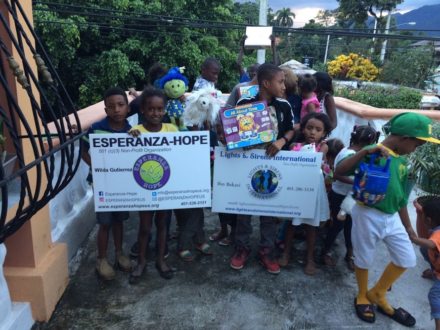 Children holding their toys and the two organizations’ placards