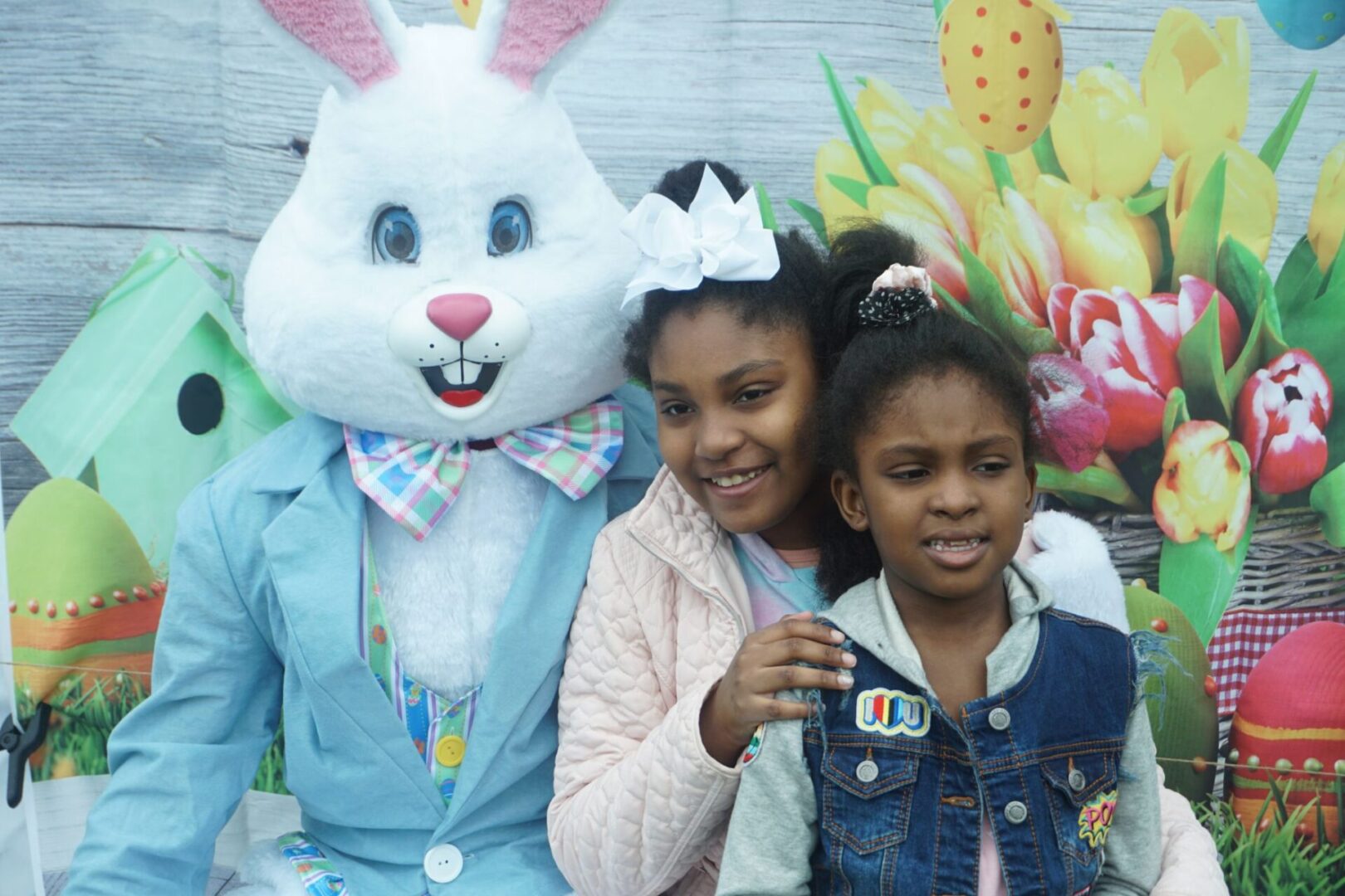 The bunny mascot and two girls with their hair tied on top