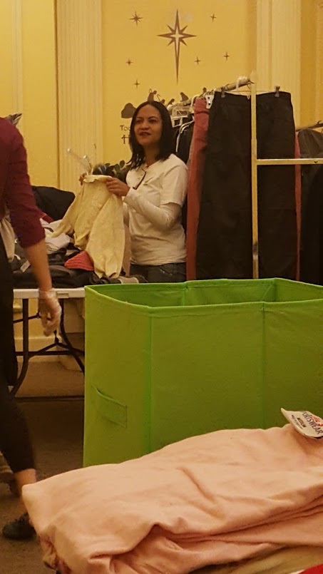 A female staff hanging a blouse on a hanger