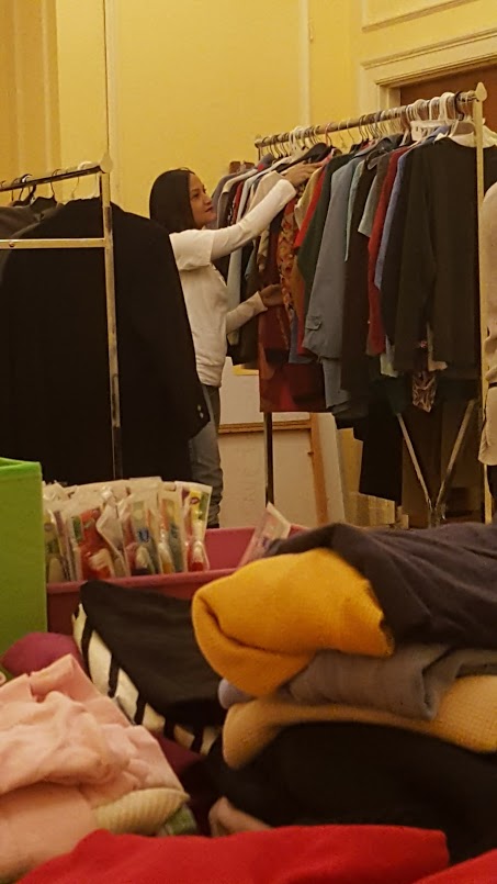 A female staff fixing the clothes on the racks