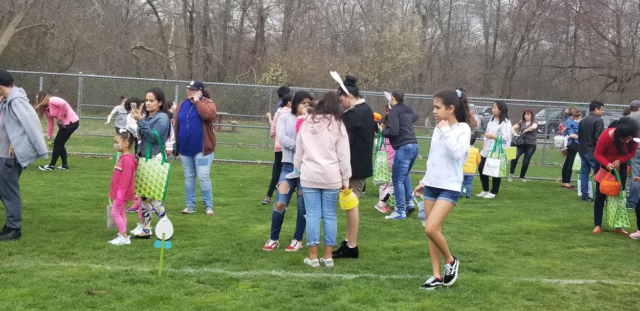 Parents and children in the Easter egg hunt field