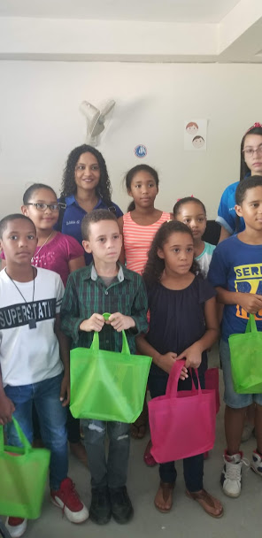 Our staff together with the children holding their tote bags