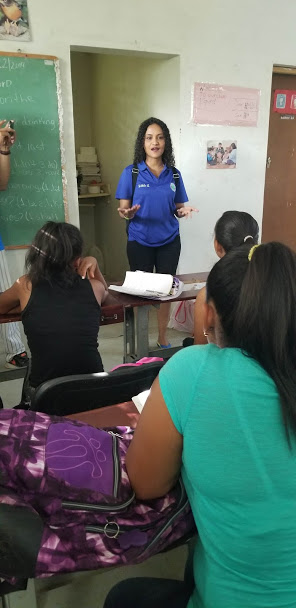 A female staff talking in front of the classroom