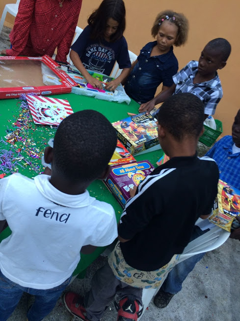 A table of children opening their boxes of toys
