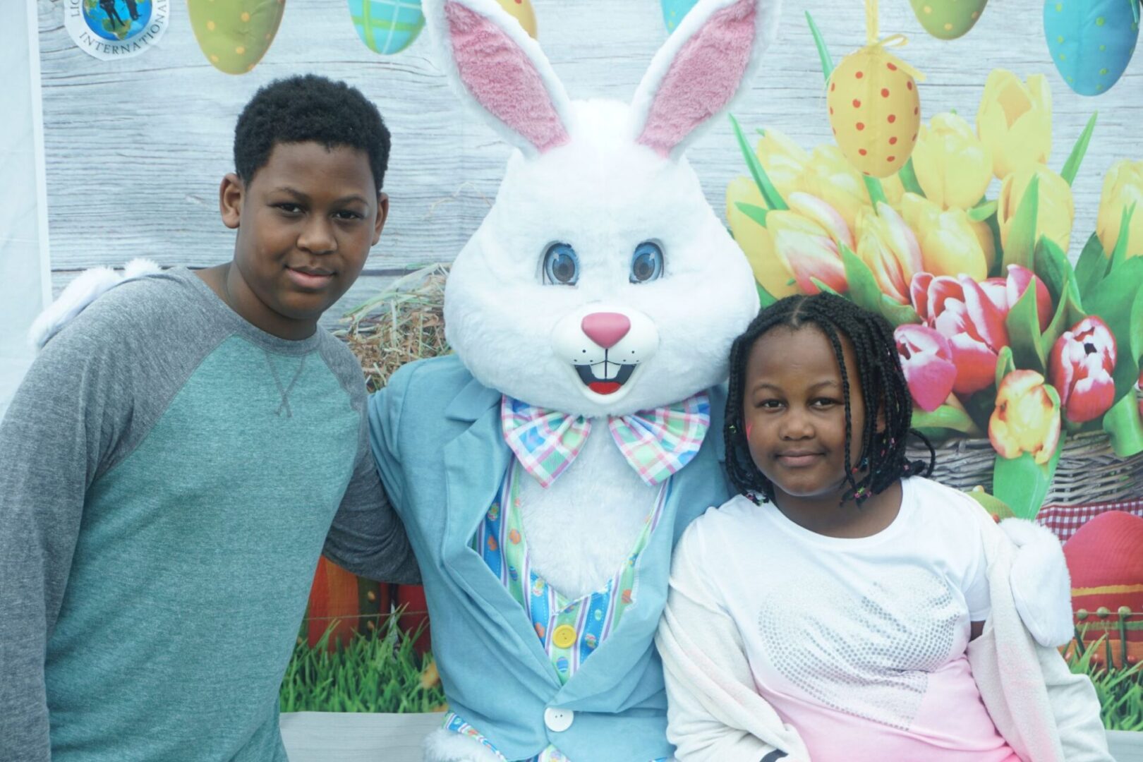 The bunny mascot together with a boy and a girl wearing blue and pink clothes, respectively (2)