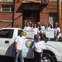 Our staff holding our organization’s placards while standing in a white pickup truck