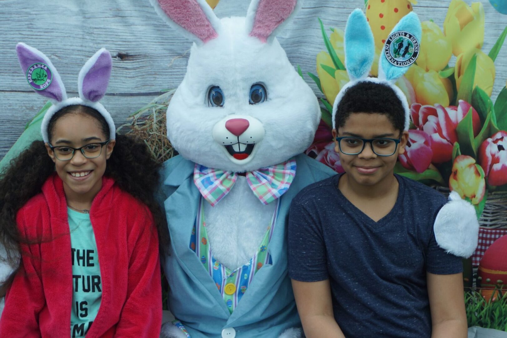 The bunny mascot together with a girl and a boy with eyeglasses and bunny ears (1)