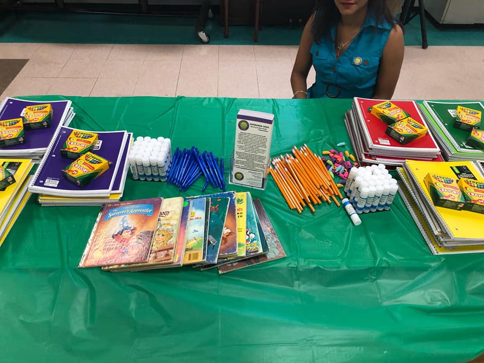Green table full of books and school supplies
