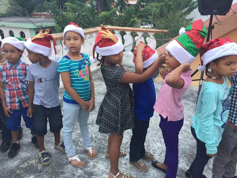 Children in line wearing Santa hats
