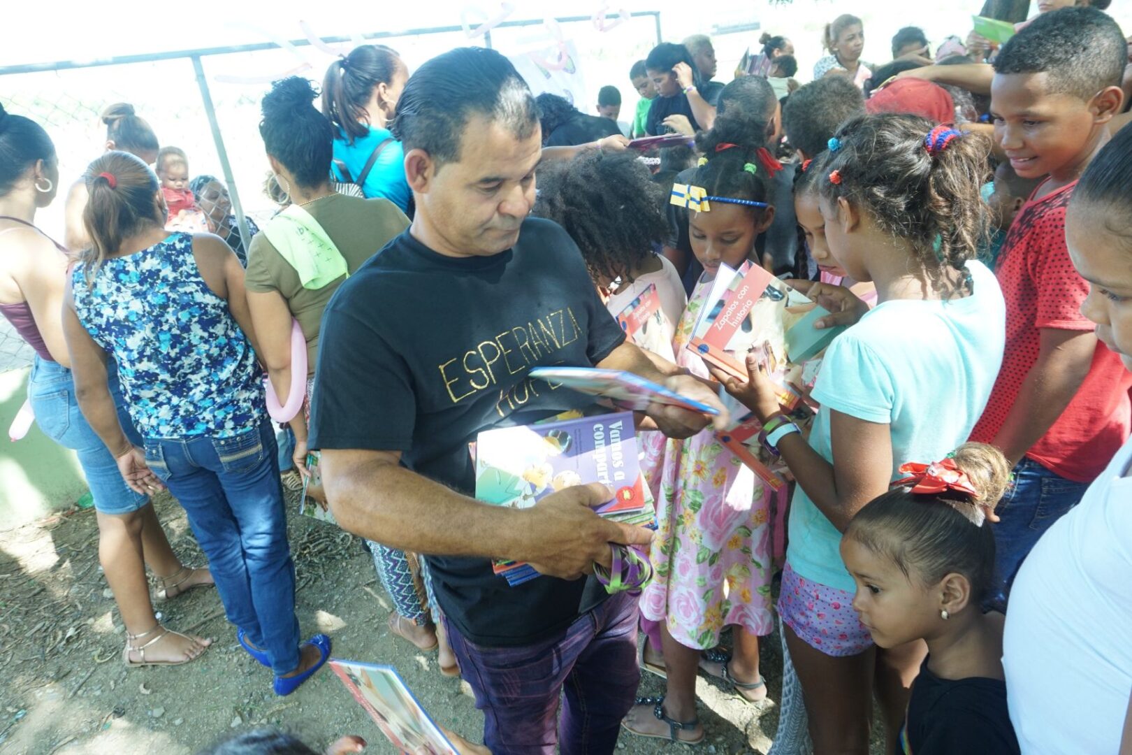 A male staff giving away books