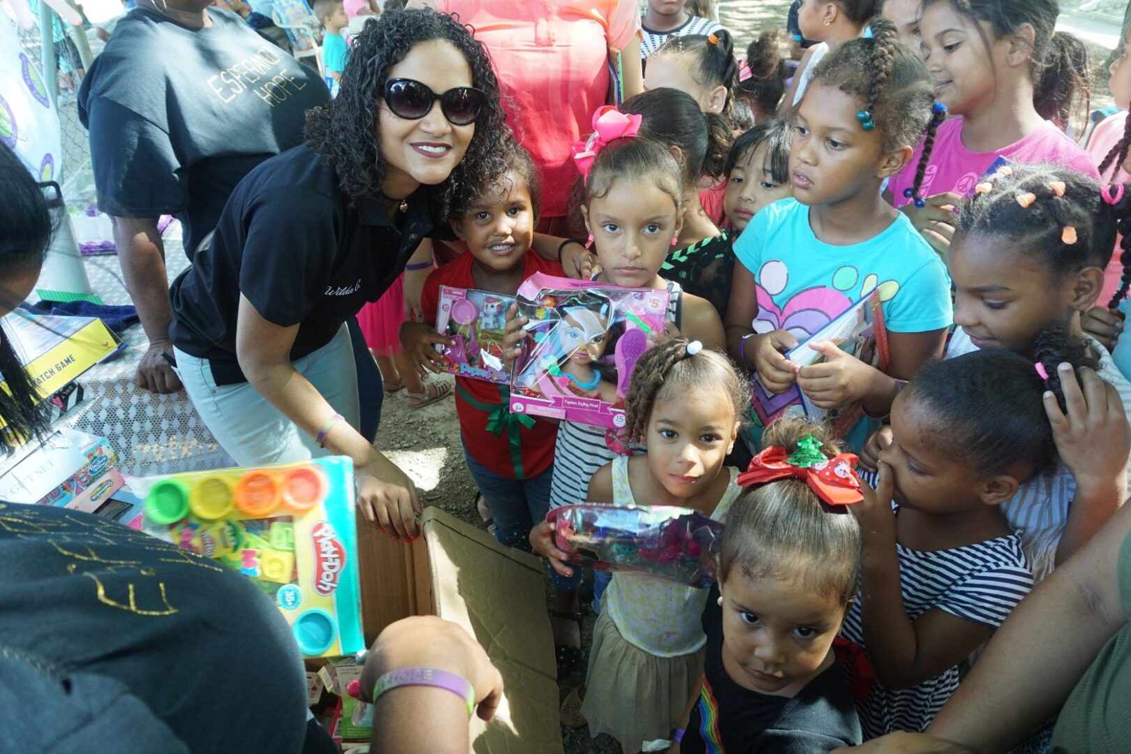 Our female staff and another group of young girls holding different kinds of dolls