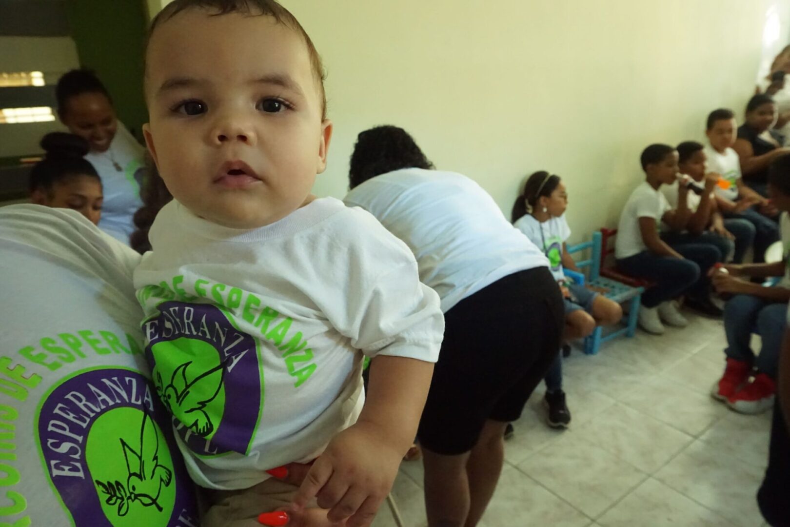 A baby wearing a white Esperanza-Hope shirt