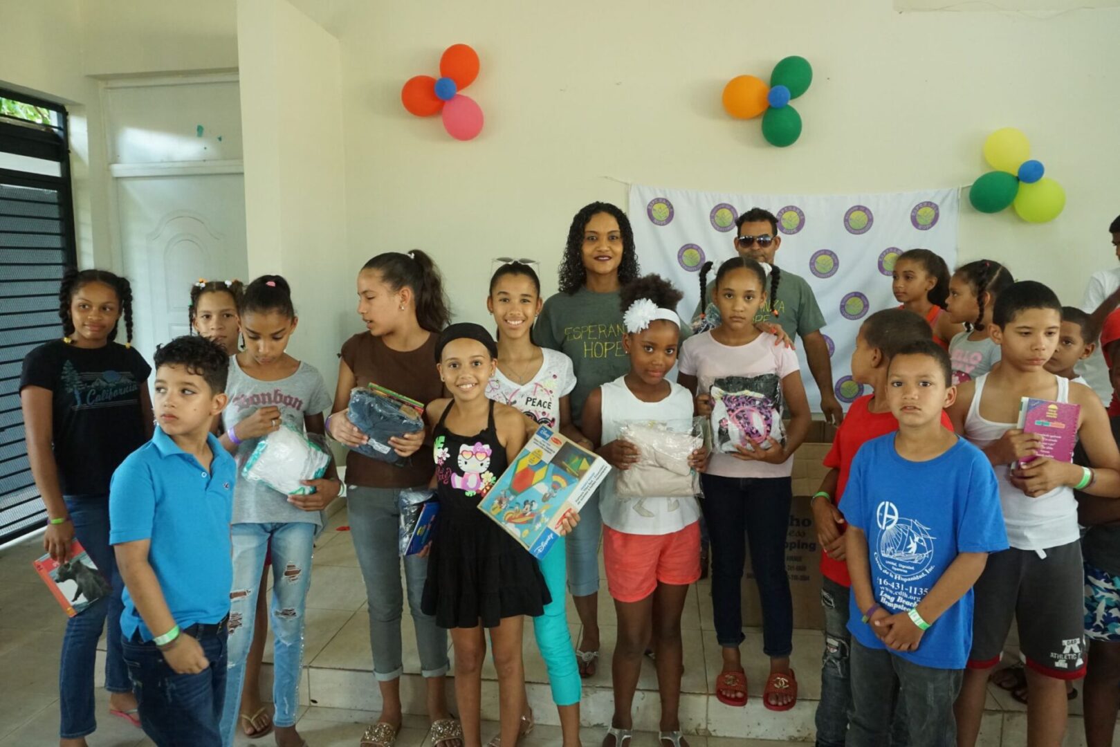 A group of girls and boys showing the gifts they received