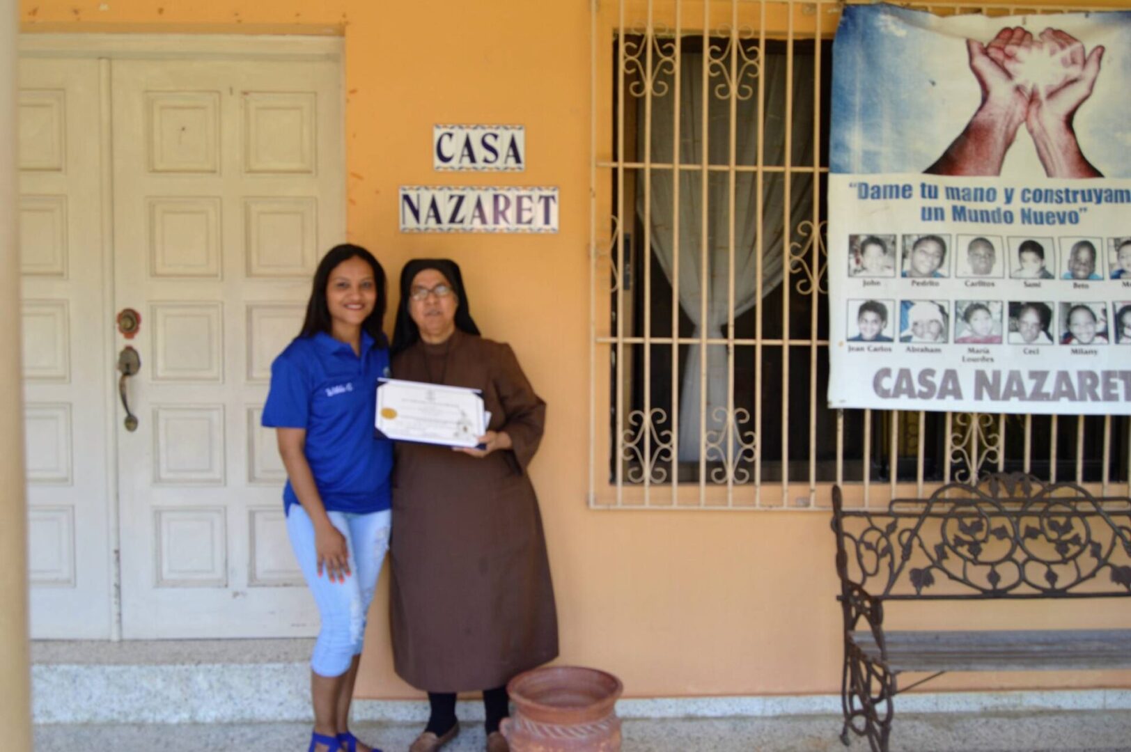 One of our female members and a nun from Casa Nazaret holding a certificate