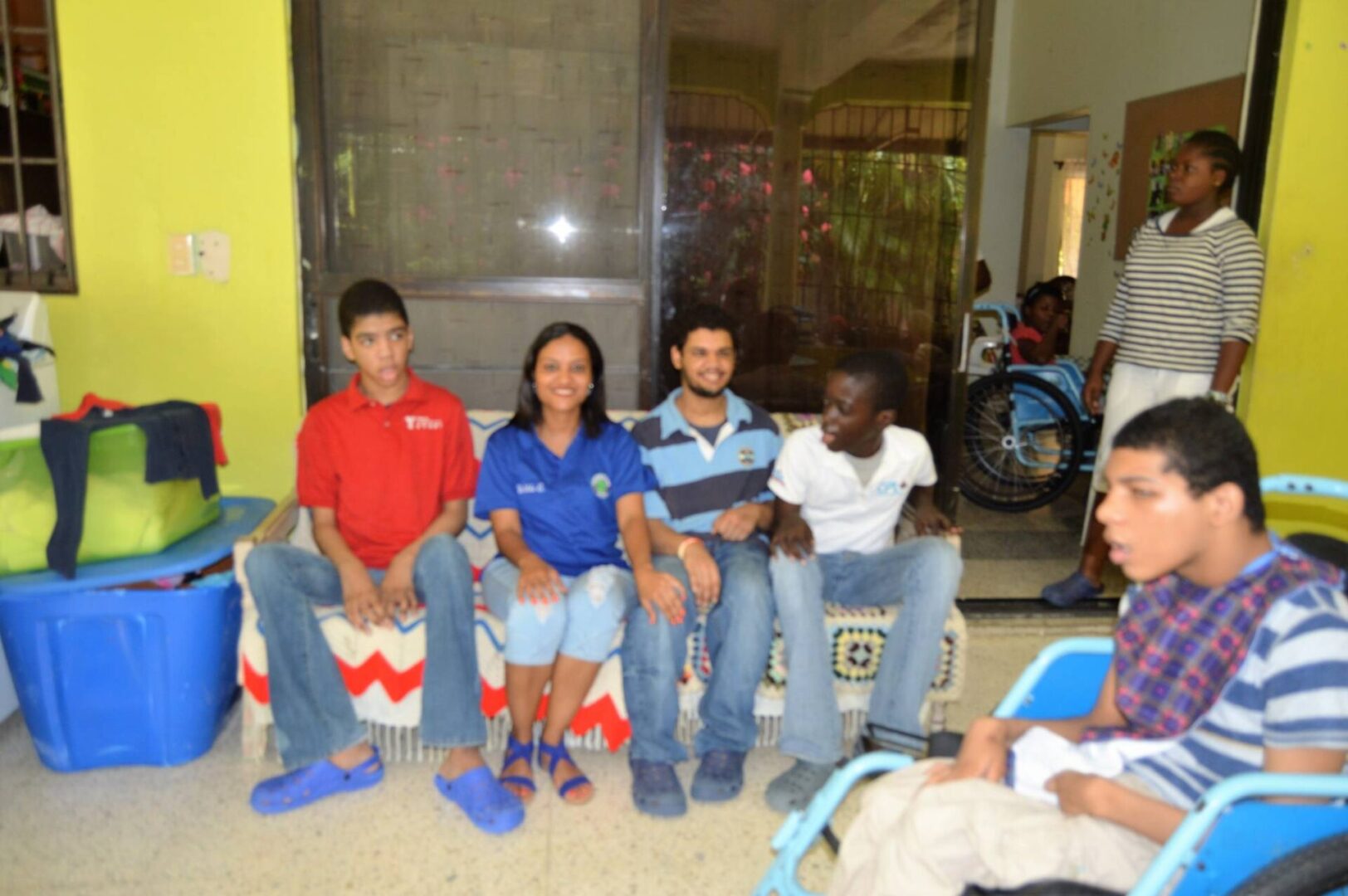 Our female staff sitting together with some of the disabled children from Casa Nazaret