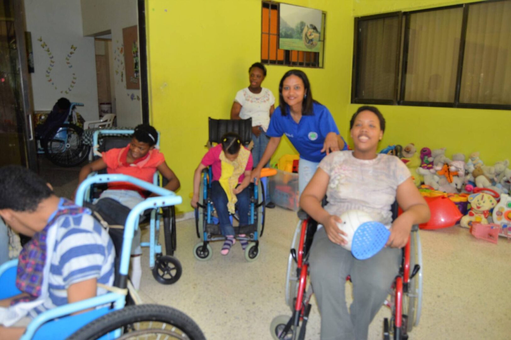 One of our female staff together with some of the girls in wheelchairs