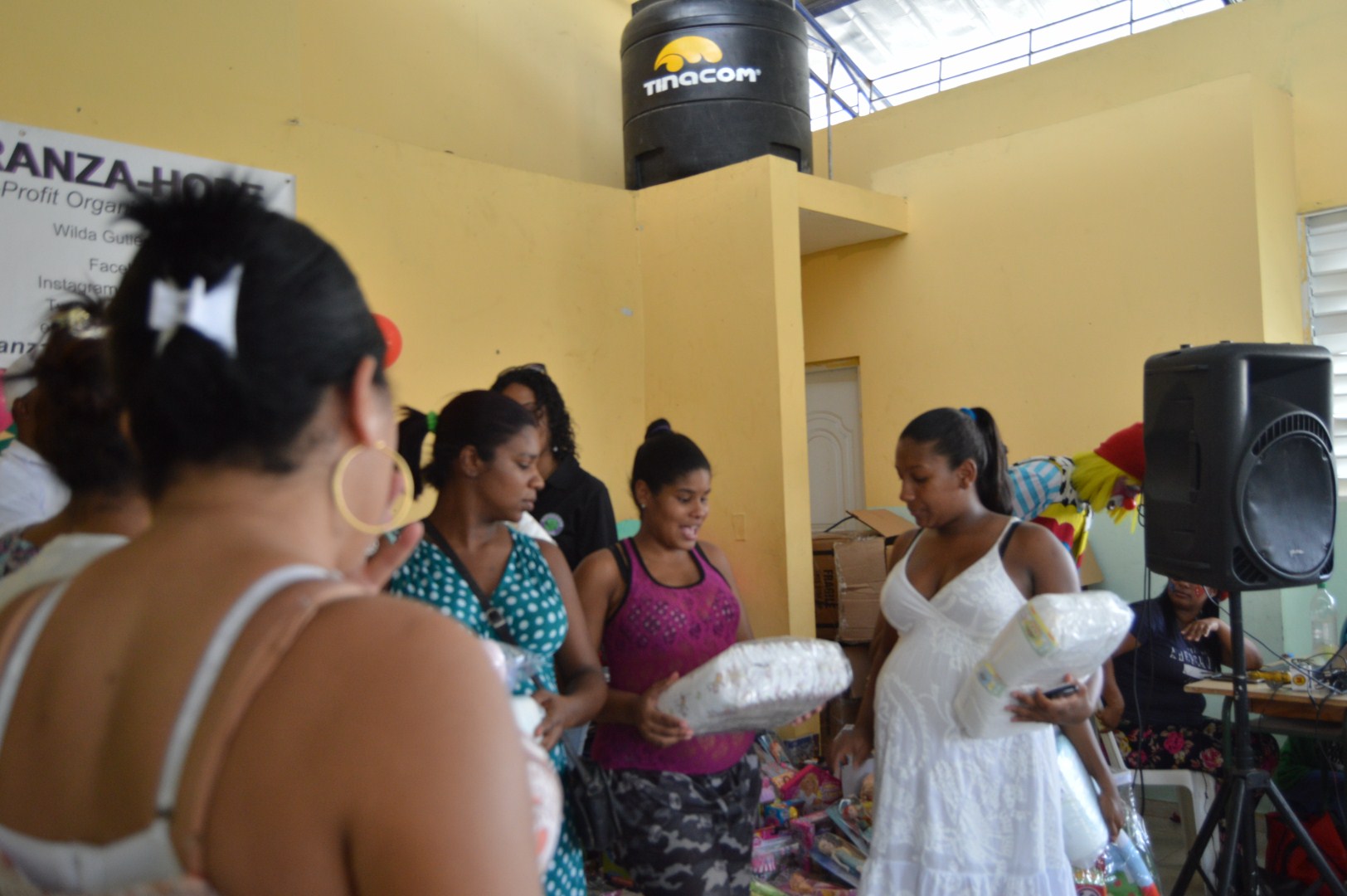 Mothers receiving packs of diapers for their babies