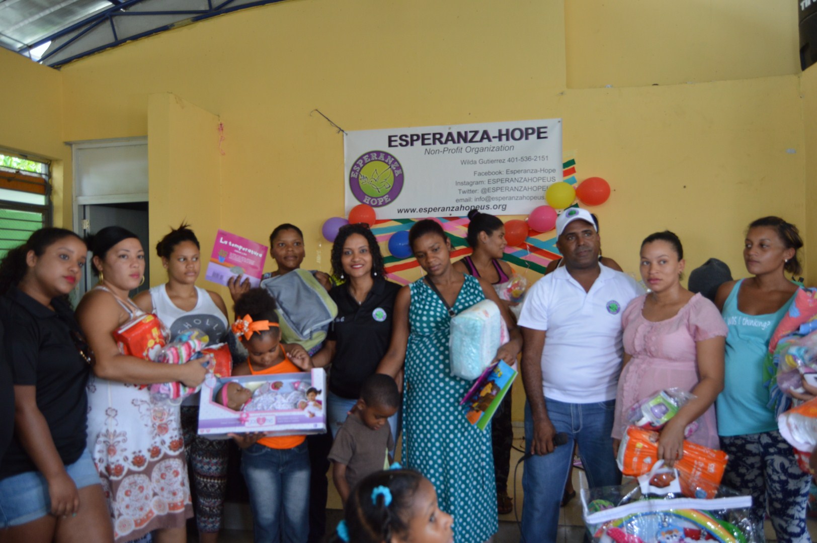 The mothers and some of their children holding toys, diapers, and clothes, different angle