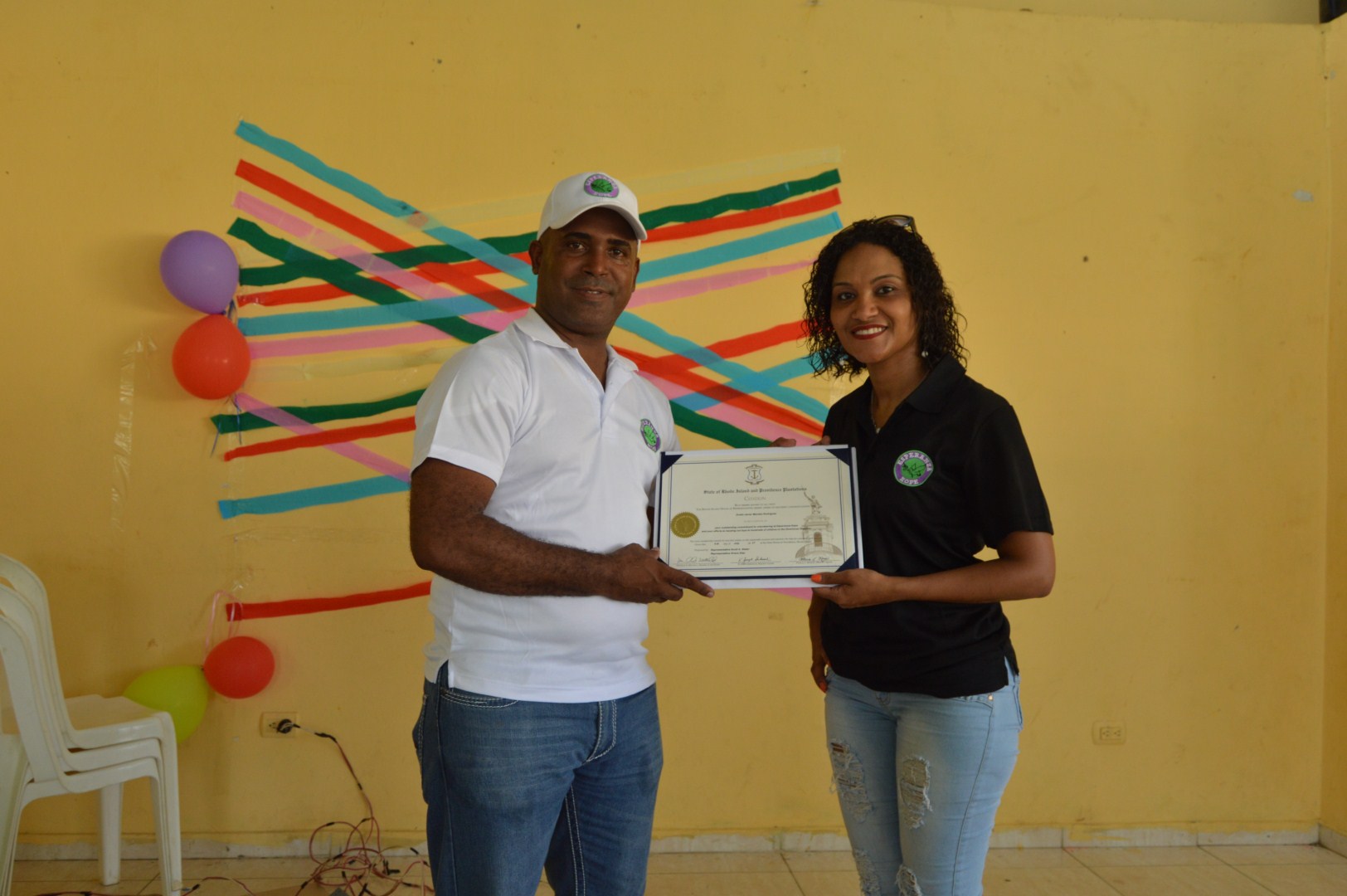 A man and a woman holding a certificate