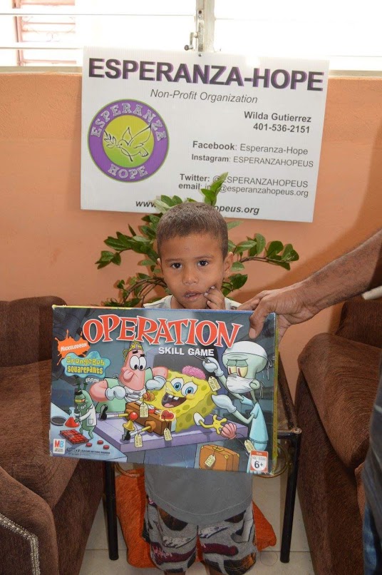 A boy holding a box of Spongebob Operation game