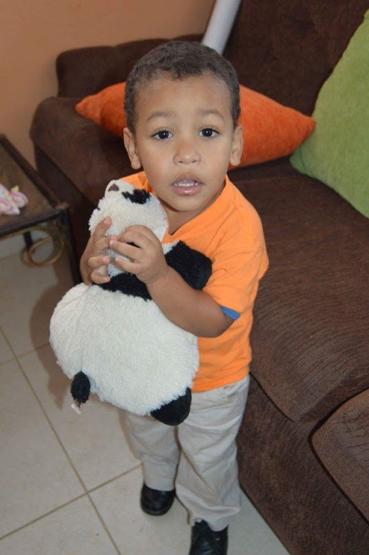 A little boy hugging his stuffed toy
