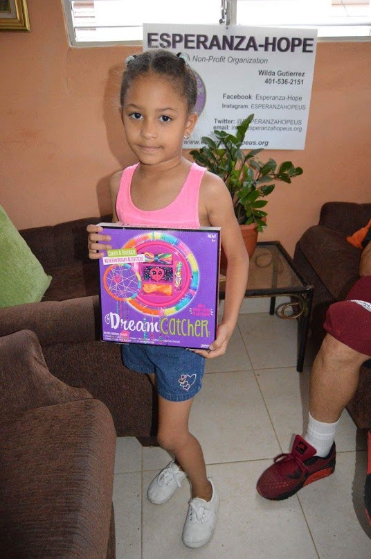 A girl holding a box of Dreamcatcher making set