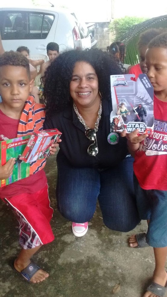 Our staff and two boys holding toys and books