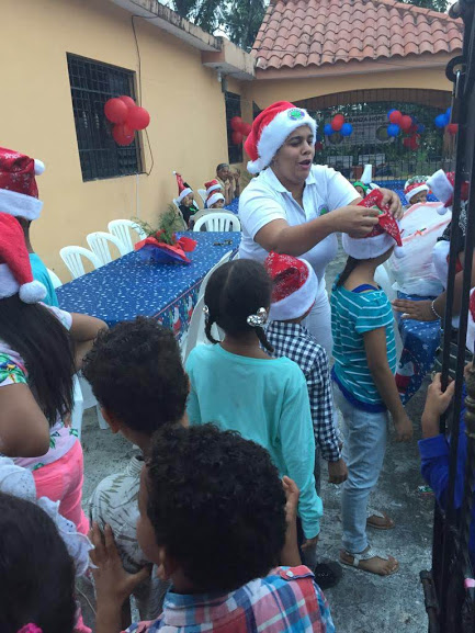 Children lining up to get Santa hats