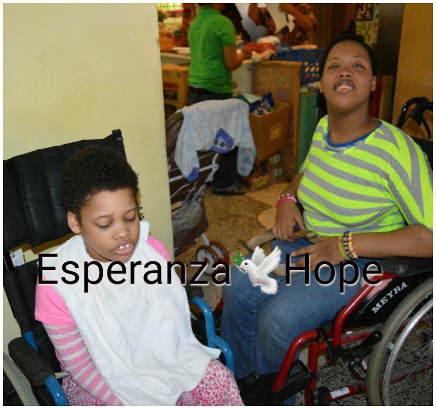 Two girls in wheelchairs, text: Esperanza-Hope