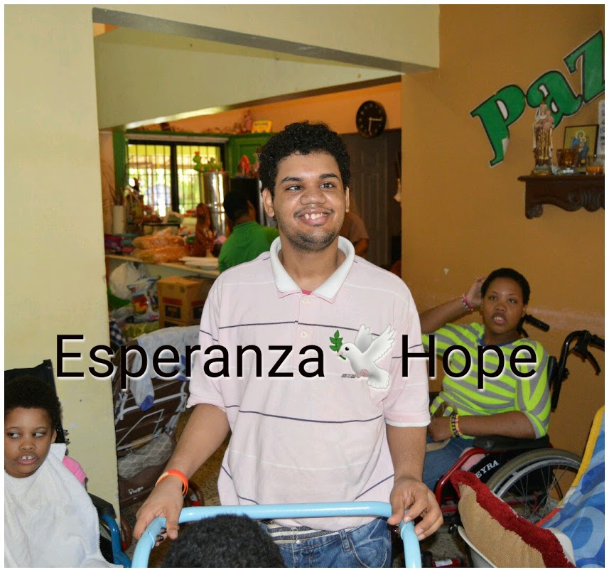 A boy in a pink shirt smiling, text: Esperanza-Hope