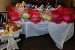 Food baskets and bags of turkey on a table with white table cloth