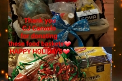 Food baskets and text, “Thank you CJ Caruolo for donating these food baskets (heart) HAPPLY HOLIDAYS (heart)”