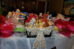 Food baskets and one basket with a big ribbon placed on the table