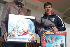 Cropped, two boys holding a Frozen toy and a Spiderman spin racer