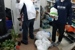 Cropped, two men and bags of turkey on the floor