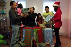 Our staff with a family of five, holding gifts (different movement)
