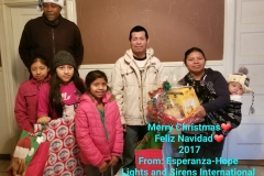 Our staff together with a couple with four children and a Merry Christmas greeting from Esperanza-Hope